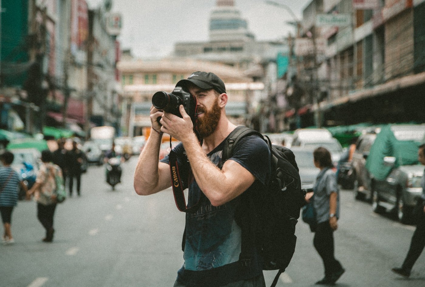 Photographer adjusting a camera before exporting web-ready images