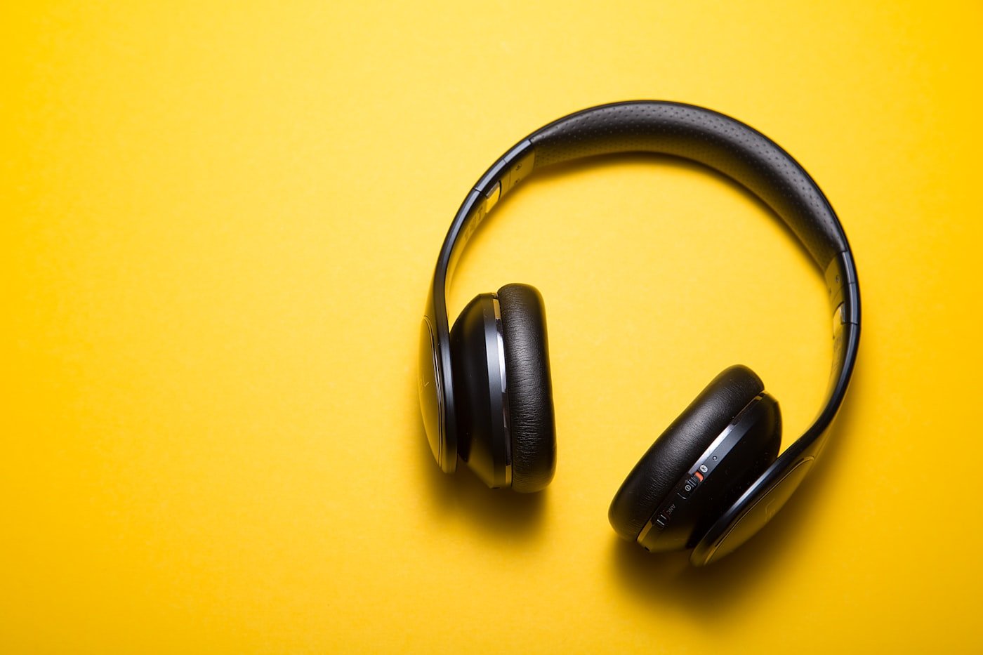 Headphones and desk setup where compressed images are uploaded