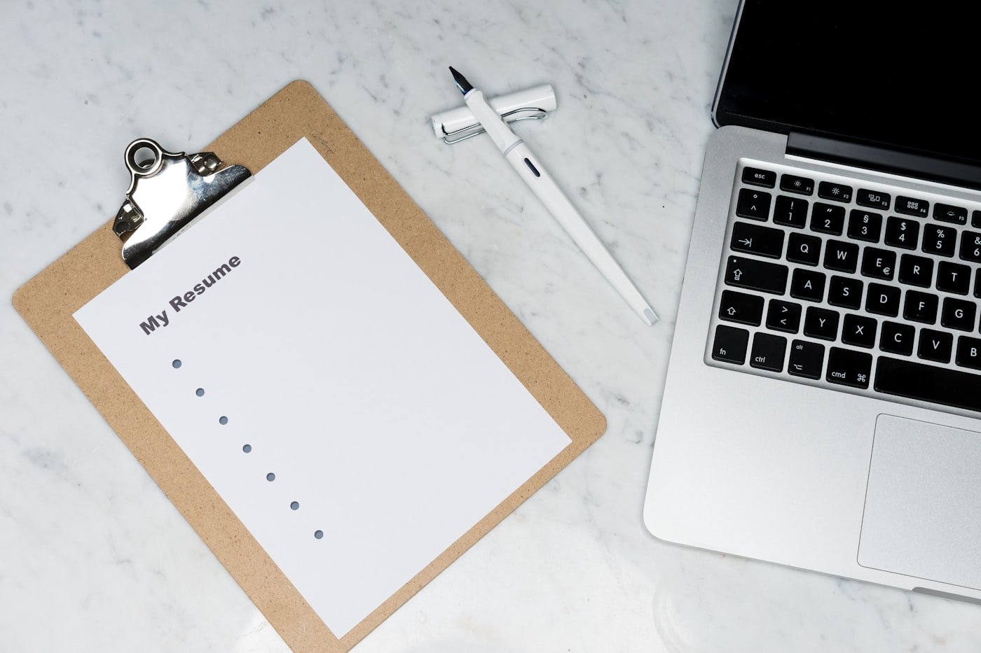 Printed forms and a pen on a desk