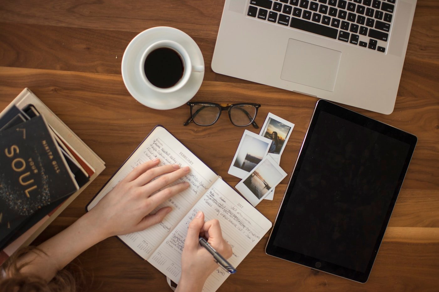 Person writing notes while preparing a document for conversion