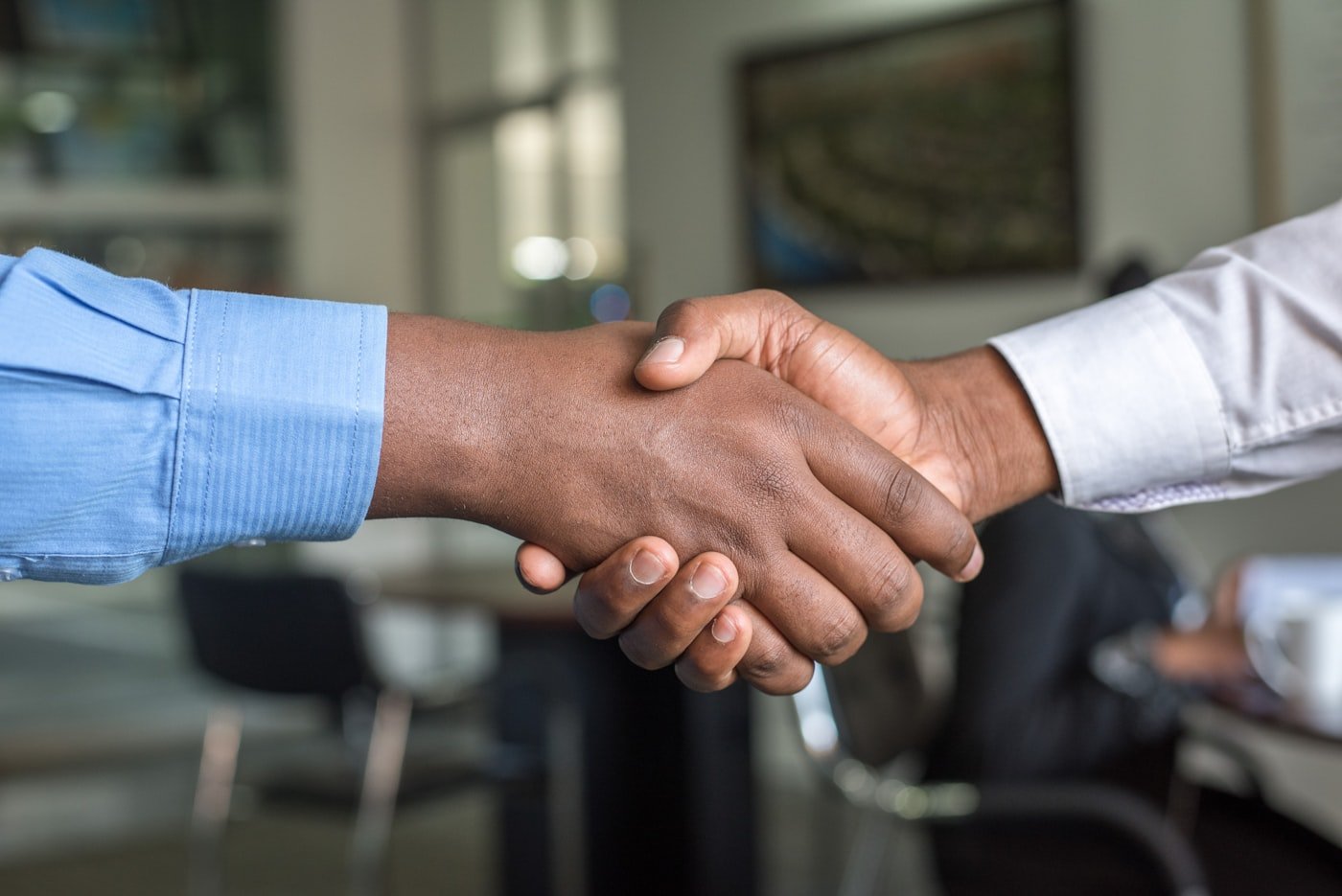Business handshake confirming an approved agreement